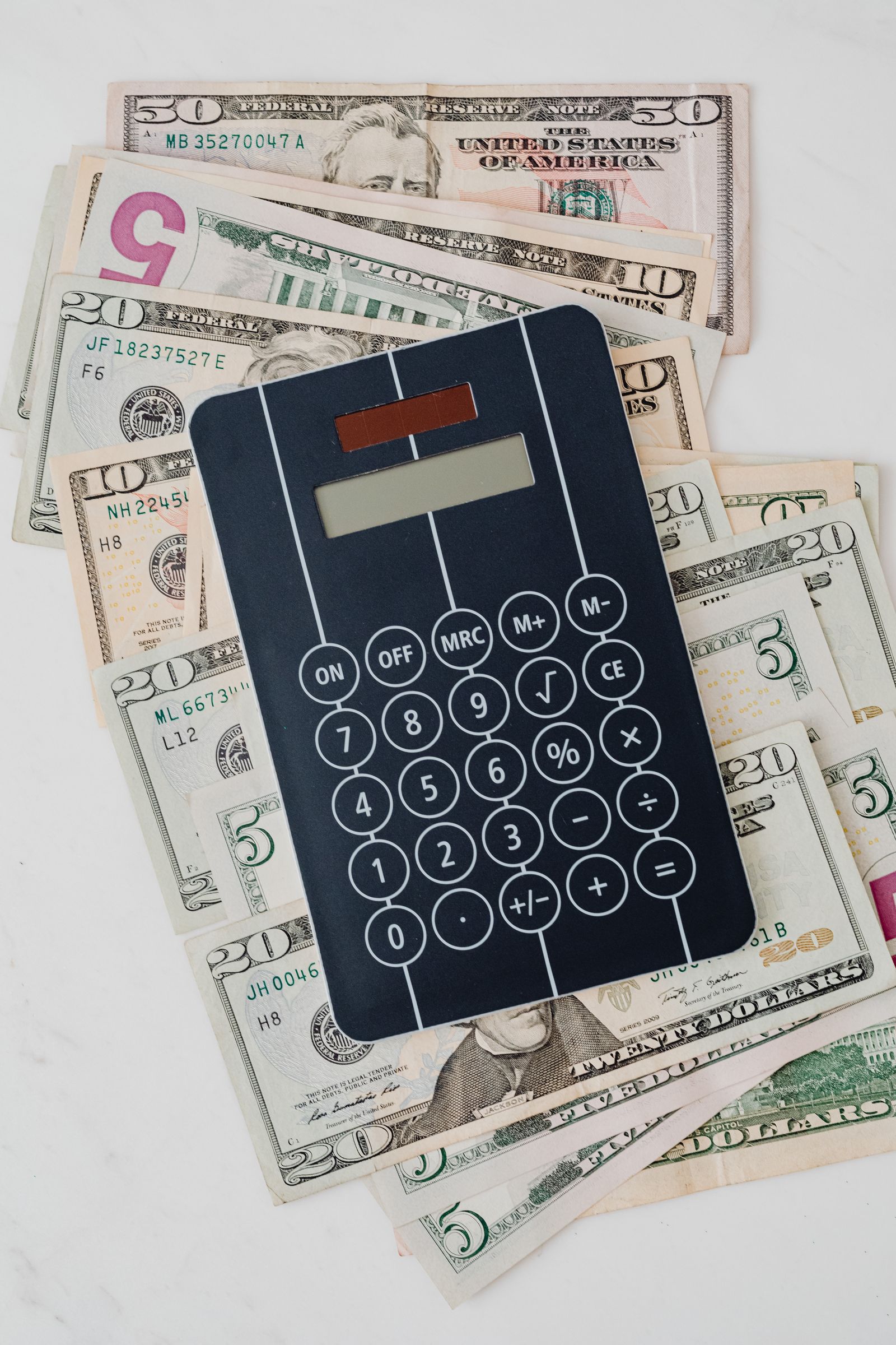 Calculator placed on US dollar banknotes